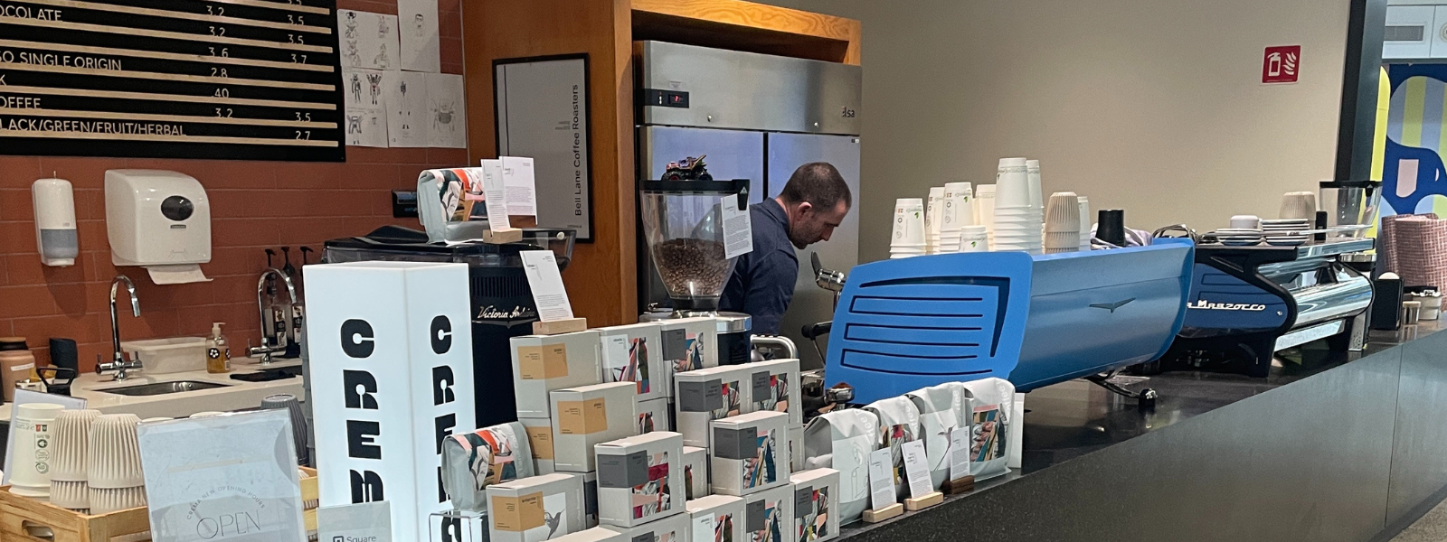 anthony ryan of crema coffee makes a coffee behind the coffee bar of crema coffee in Meta's Dublin HQ
