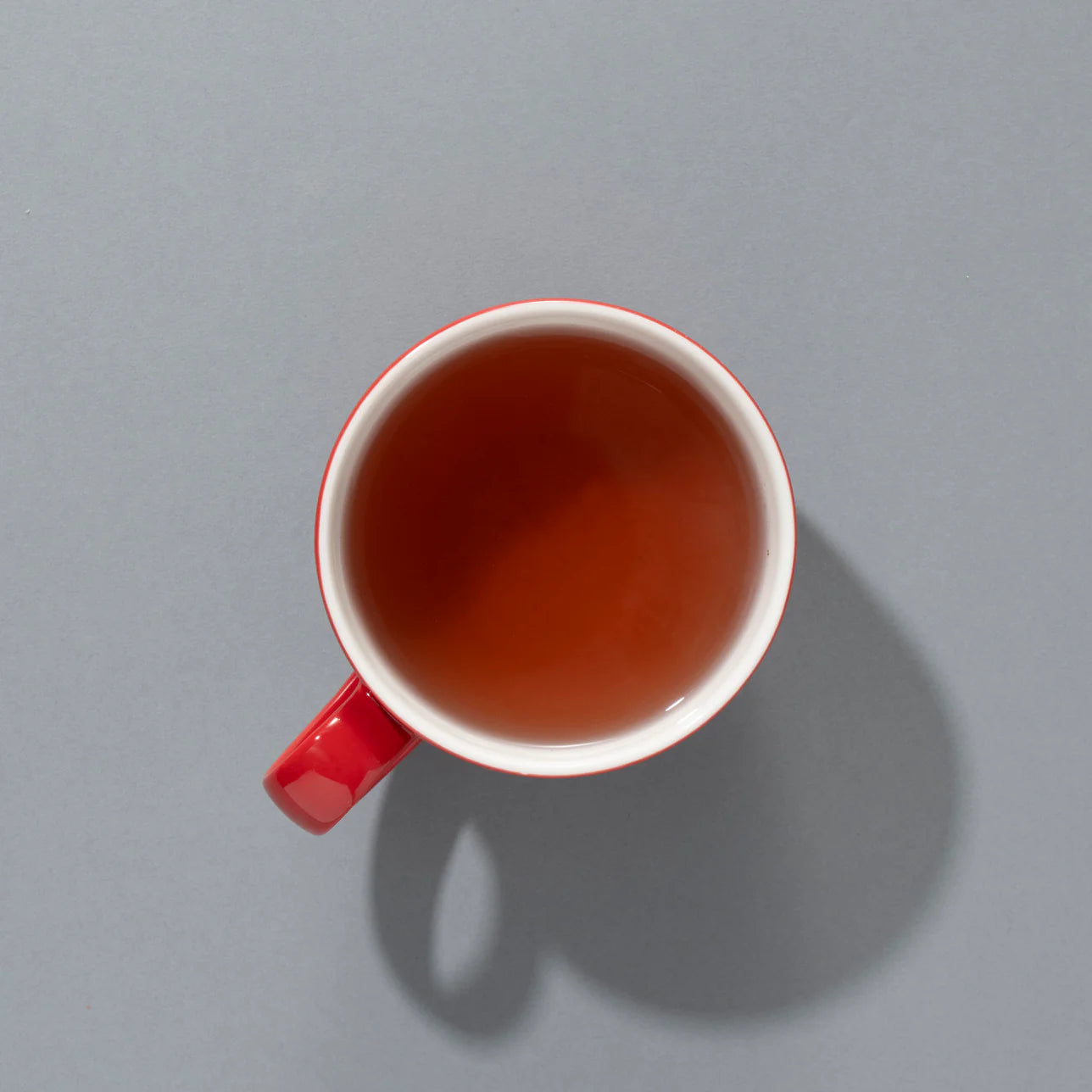 Top-down view of brewed Red Berry tea in a red cup with a deep red hue.
